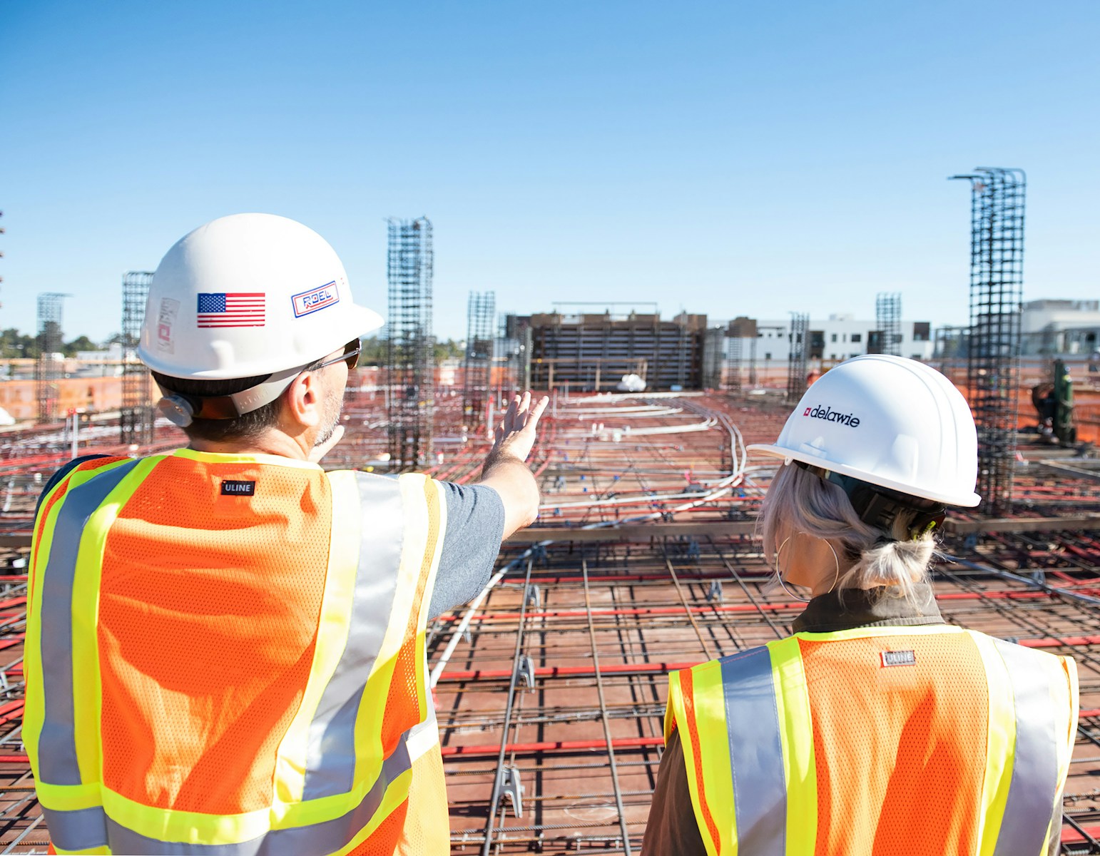 man in white hard hat standing on brown wooden dock during daytime, contractors