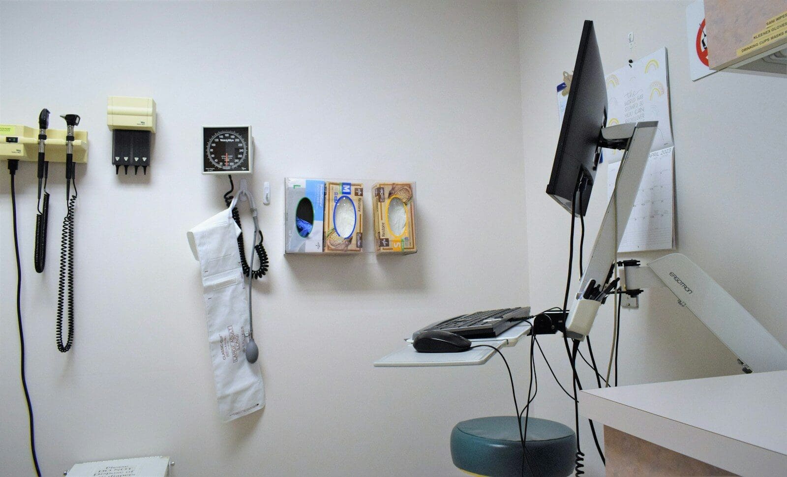 a room with a desk, phone, and other items on the wall